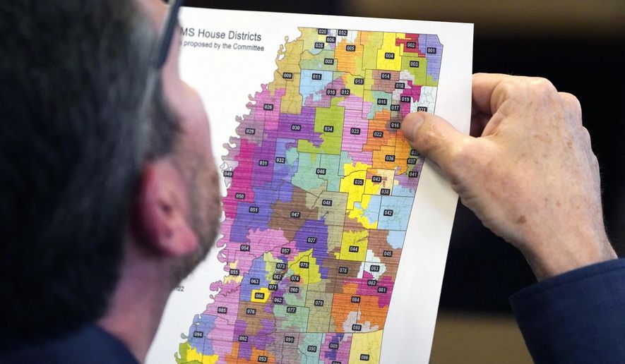 Rep. Dan Eubanks, R-Walls, examines a copy of the House redistricting map during a meeting of the House Legislative Reapportionment Committee, Sunday, March 27, 2022, at the Mississippi Capitol in Jackson. (AP Photo/Rogelio V. Solis)