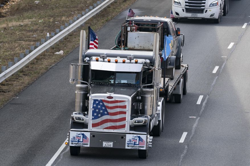 A convoy of trucks and other vehicles travels the I-495 Capital Beltway near the Woodrow Wilson Bridge, to protest mandates and other issues, Sunday, March, 6, 2022, in Fort Washington, Md. (AP Photo/Alex Brandon) ** FILE **