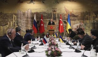 In this photo provided by Turkish Presidency, Turkish President Recep Tayyip Erdogan, center, gives a speech to welcome the Russian, left, and Ukrainian delegations ahead of their talks, in Istanbul, Turkey, Tuesday, March 29, 2022. The first face-to-face talks in two weeks between Russia and Ukraine were due to start Tuesday, raising flickering hopes of an end to a war that has ground into a bloody campaign of attrition. (Turkish Presidency via AP)