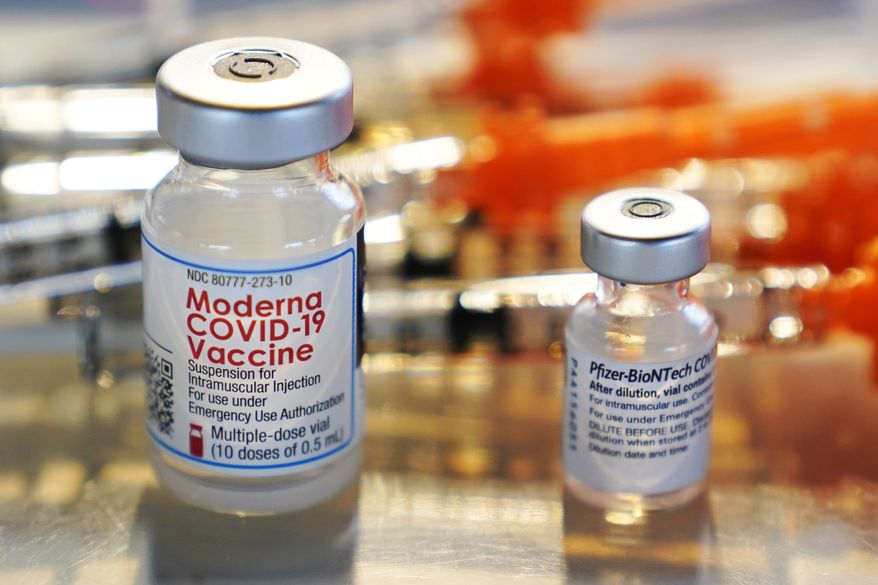Vials for the Moderna and Pfizer COVID-19 vaccines are seen at a temporary clinic in Exeter, N.H. on Thursday, Feb. 25, 2021. The Food and Drug Administration has authorized another booster dose of the Pfizer or Moderna COVID-19 vaccine for people age 50 and up, Tuesday, March 29, 2022. (AP Photo/Charles Krupa, File)