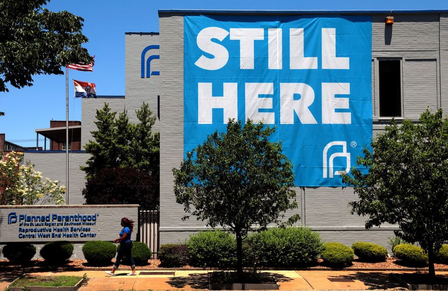 FILE - In this May 29, 2020, file photo, a banner hangs on the side of the Planned Parenthood building in St. Louis. The Missouri House is advancing a bill to defund Planned Parenthood and put more restrictions on abortions. The GOP-led House gave the measure initial approval in a voice vote Tuesday, March 29, 2022. (Robert Cohen/St. Louis Post-Dispatch via AP, File)