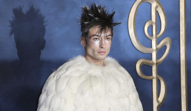 REPLACES HE WITH MILLER - FILE - Actor Ezra Miller poses for photographers upon arrival at the premiere of the film 'Fantastic Beasts: The Crimes of Grindelwald', at a central London cinema, Tuesday, Nov. 13, 2018. Miller known for playing "The Flash" in "Justice League" films was arrested after an incident at a Hawaii karaoke bar, Sunday, where police say Miller yelled obscenities, grabbed a mic from a singing woman and lunged at a man playing darts. .(Photo by Grant Pollard/Invision/AP,File)