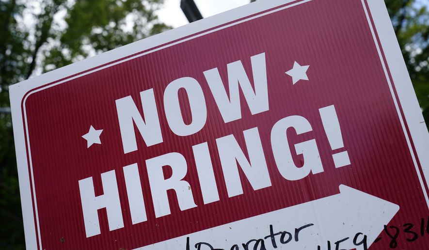 A &quot;now hiring&quot; sign is posted in Garnet Valley, Pa., Monday, May 10, 2021. Job openings stayed at a near-record level in February, 2022, little changed from the previous month, continuing a trend that Federal Reserve officials see as a driver of inflation. (AP Photo/Matt Rourke, File )