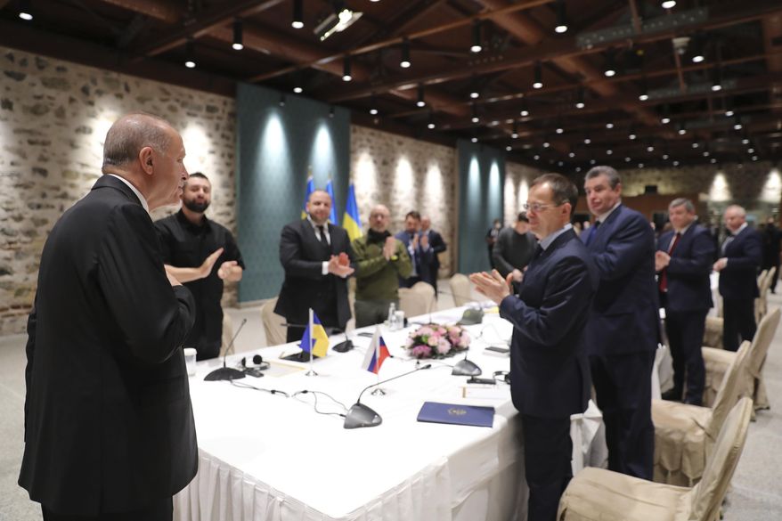 In this photo provided by Turkish Presidency, Turkish President Recep Tayyip Erdogan, left, welcomes the Russian, right, and Ukrainian delegations ahead of their talks in Istanbul, Turkey, Tuesday, March 29, 2022. The first face-to-face talks in two weeks between Russia and Ukraine were due to start Tuesday, raising flickering hopes of an end to a war that has ground into a bloody campaign of attrition. (Turkish Presidency via AP)
