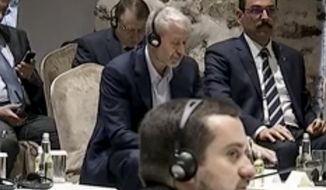 In this image taken from a video provided by the Turkish Presidency, Russian Roman Abramovich, center, listens to Turkish President Recep Tayyip Erdogan during the Russian and Ukrainian delegations meeting for talks in Istanbul, Turkey, Tuesday, March 29, 2022. Erdogan called for a cease-fire as the Russian and Ukrainian delegations resumed their two days of talks in Istanbul. (Turkish Presidency via AP)