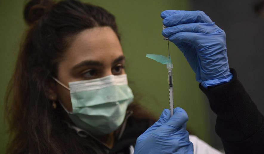 A medical staff member prepares a Pfizer vaccine during a COVID-19 vaccination campaign in Pamplona, northern Spain, on March 16, 2021. The European Medicines Agency said it has begun an accelerated review process for an experimental coronavirus vaccine booster made by the Spanish company Hipra. In a statement on Tuesday, the EU medicines regulator said its evaluation is based on preliminary data from laboratory studies and research in adults that compared Hipra’s booster shot to the vaccine made by Pfizer-BioNTech. (AP Photo/Alvaro Barrientos, File)