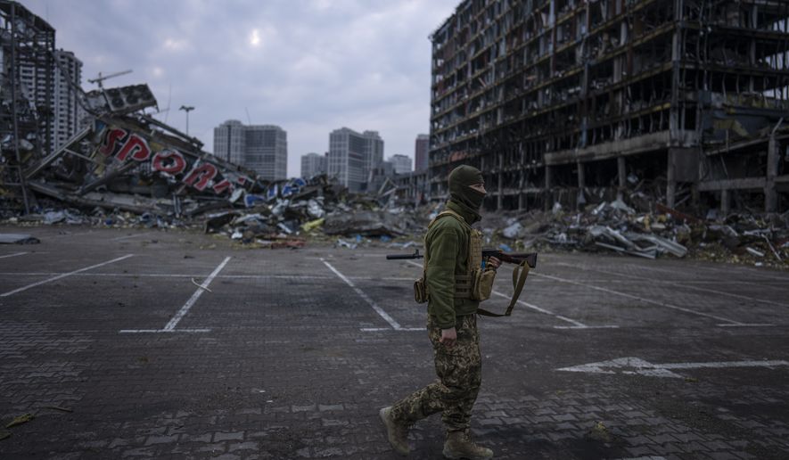 A soldier walks the amid the destruction caused after shelling of a shopping center last March 21 in Kyiv, Ukraine, Wednesday, March 30, 2022. (AP Photo/Rodrigo Abd)