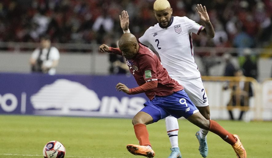 United States&#39; Deandre Yedlin, right, and Costa Rica&#39;s Jewison Bennette battle for the ball during a qualifying soccer match for the FIFA World Cup Qatar 2022 in San Jose, Costa Rica, Wednesday, March 30, 2022. (AP Photo/Moises Castillo)