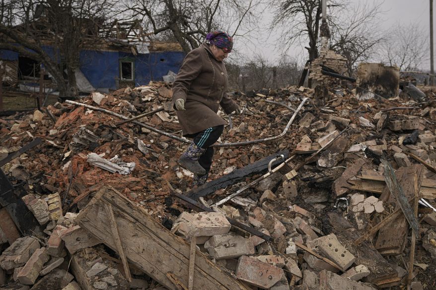 Mariya, a local resident, looks for personal items in the rubble of her house, destroyed during fighting between Russian and Ukrainian forces in the village of Yasnohorodka, on the outskirts of Kyiv, Ukraine, Wednesday, March 30, 2022. (AP Photo/Vadim Ghirda)