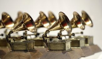 FILE - Grammy Awards are displayed at the Grammy Museum Experience at Prudential Center in Newark, N.J. on Oct. 10, 2017. The 64th annual Grammy Awards will be held in Las Vegas on April 3. (AP Photo/Julio Cortez, File)