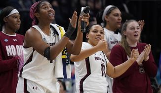 South Carolina&#x27;s Aliyah Boston cheers from the bench in the final seconds of the second half of a college basketball game in the semifinal round of the Women&#x27;s Final Four NCAA tournament Friday, April 1, 2022, in Minneapolis. (AP Photo/Charlie Neibergall)
