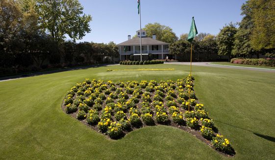 Flowers grace the entrance to the clubhouse at the Augusta National Golf Club as preparations continue for the Masters golf tournament in Augusta, Ga., on Sunday, April 3, 2011.  The Masters starts Thursday, April 7, 2022 and the course at Augusta National is among the most famous in the world because it hosts the only major held in the same place. Most memorable is the back nine because of the two par-5 holes that can be reached in two.  (AP Photo/Dave Martin, File) **FILE**