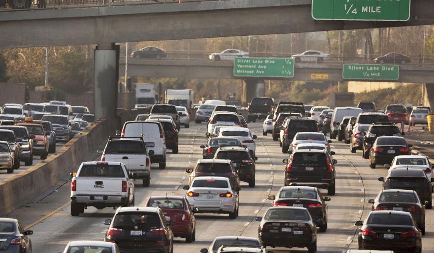 This Dec. 12, 2018, file photo shows traffic on the Hollywood Freeway in Los Angeles. New vehicles sold in the U.S. will have to travel an average of at least 40 miles per gallon of gasoline in 2026 under new rules unveiled by the government. The National Highway Traffic Safety Administration said Friday its fuel economy requirements will undo a rollback enacted under President Donald Trump. (AP Photo/Damian Dovarganes, File) **FILE**