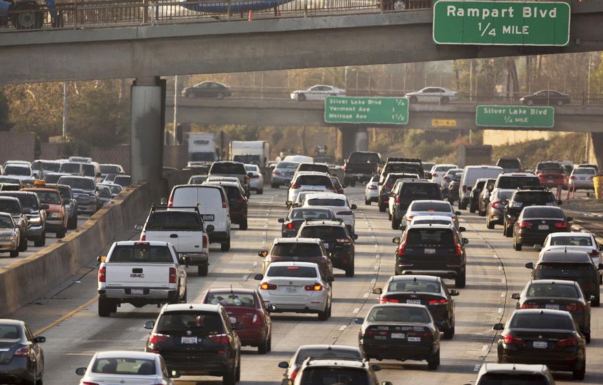 This Dec. 12, 2018, file photo shows traffic on the Hollywood Freeway in Los Angeles. New vehicles sold in the U.S. will have to travel an average of at least 40 miles per gallon of gasoline in 2026 under new rules unveiled by the government. The National Highway Traffic Safety Administration said Friday its fuel economy requirements will undo a rollback enacted under President Donald Trump. (AP Photo/Damian Dovarganes, File) **FILE**