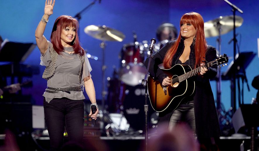 FILE - Naomi Judd, left, and Wynonna Judd, of The Judds, perform at the Girls&#39; Night Out: Superstar Women of Country in Las Vegas on April 4, 2011. The Judds are reuniting to perform their song “Love Will Be A Bridge” on the CMT Music Awards, April 11 on CBS. (AP Photo/Julie Jacobson, File)