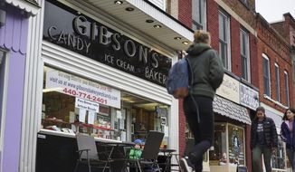 In this Nov. 22, 2017, file photo, pedestrians pass the storefront of Gibson&#39;s Bakery in Oberlin, Ohio. (AP Photo/Dake Kang, File)