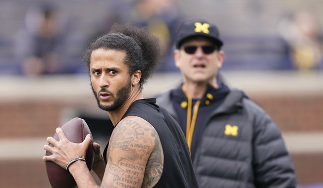 Michigan head football coach Jim Harbaugh watches as former NFL quarterback Colin Kaepernick throws during halftime of an NCAA college football intra-squad spring game, Saturday, April 2, 2022, in Ann Arbor, Mich. (AP Photo/Carlos Osorio) **FILE**