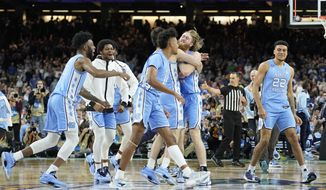 North Carolina players celebrate after beating Duke in a college basketball game during the semifinal round of the Men&#x27;s Final Four NCAA tournament, Saturday, April 2, 2022, in New Orleans. (AP Photo/David J. Phillip)