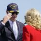 President Joe Biden salutes first lady Jill Biden after he introduced her to speak during a commissioning ceremony for USS Delaware, Virginia-class fast-attack submarine, at the Port of Wilmington in Wilmington, Del., Saturday, April 2, 2022. (AP Photo/Carolyn Kaster)