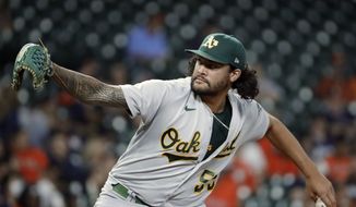Oakland Athletics starting pitcher Sean Manaea throws against the Houston Astros during the first inning of a baseball game, Oct. 1, 2021, in Houston. The San Diego Padres bolstered their rotation on Sunday, April 3, 2022, acquiring left-hander Manaea in a trade with the Athletics. (AP Photo/Michael Wyke, File) **FILE**