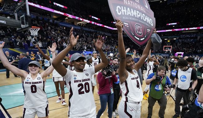 South Carolina players celebrate after a college basketball game in the final round of the Women&#x27;s Final Four NCAA tournament against UConn Sunday, April 3, 2022, in Minneapolis. South Carolina won 64-49 to win the championship. (AP Photo/Eric Gay)