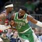 Washington Wizards guard Kentavious Caldwell-Pope, left, defends against Boston Celtics guard Jaylen Brown (7) in the second half of an NBA basketball game, Sunday, April 3, 2022, in Boston. (AP Photo/Steven Senne)