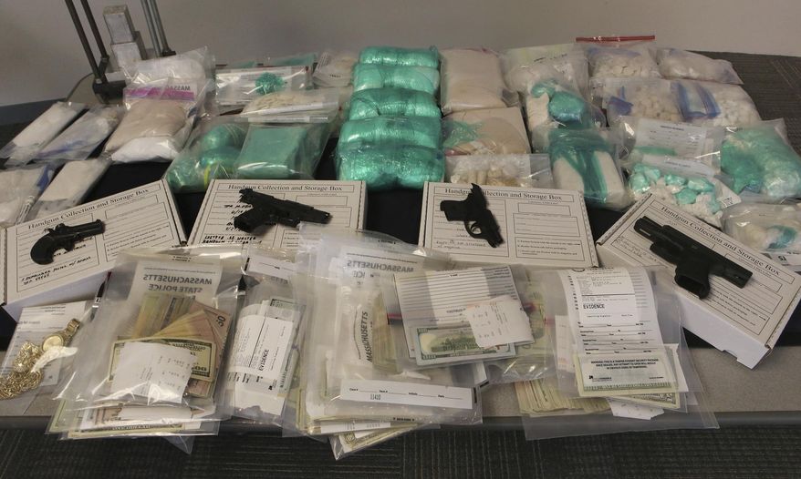 Guns, drugs and money are displayed at a press conference, Thursday, June 20, 2019, in Boston. Federal prosecutors announced charges Tuesday against two Cleveland men they say were trying to sell serious firepower to Mexican smuggling cartels. (Nancy Lane/The Boston Herald via AP, File)