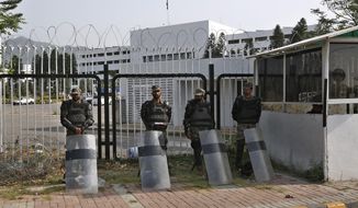 Pakistani paramilitary troops stand guard with riot gears outside the National Assembly, in Islamabad, Pakistan, Sunday, April 3, 2022. Pakistan&#39;s embattled prime minister faces a no-confidence vote in Parliament on Sunday and the opposition said it has the numbers to win after Imran Khan&#39;s allies and partners in a fragile coalition abandoned him. (AP Photo/Anjum Naveed)