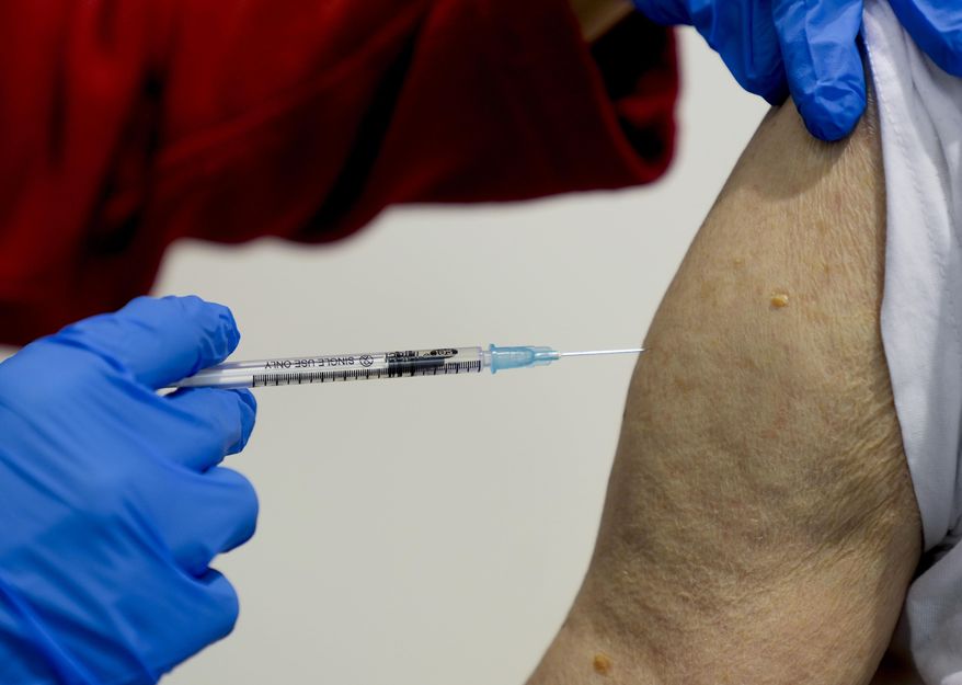 This file photo shows an 87-year-old man getting his booster shot at the vaccination center in Frankfurt, Germany, Thursday, Nov. 11, 2021. A 60-year-old man allegedly had himself vaccinated against COVID-19 dozens of times in Germany in order to sell forged vaccination cards with real vaccine batch numbers. (AP Photo/Michael Probst,file)