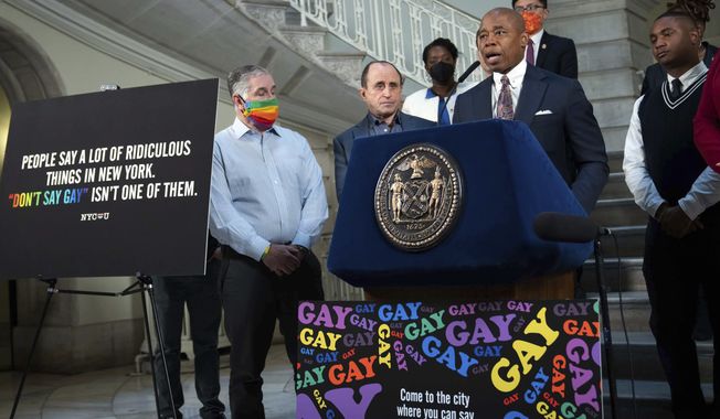New York Mayor Eric Adams, at podium, addresses a news conference in the rotunda of City Hall, in New York, Monday, April 4, 2022. New York City is launching a digital billboard campaign, supporting LGBTQ visibility that will be displayed in five major markets in Florida for eight weeks, to lure Floridians unhappy with their state&#x27;s &quot;Don&#x27;t Say Gay&quot; law to the Big Apple, Adams announced. (Ed Reed/Office of the New York City Mayor via AP)