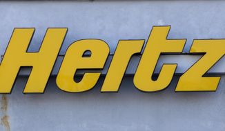 In this Nov. 28, 2017 photo a Hertz rental car logo rests on the front of a Hertz location, in Boston. Hertz is planning to buy up to 65,000 electric vehicles from Swedish premium electric car maker Polestar over the next five years as it looks to boost its electric vehicle rental fleet. Financial terms were not disclosed. The vehicles are expected to be available in Europe in the spring and in North America and Australia later this year. The announcement on Monday, April 4, 2022 comes more than five months after Hertz said that it will buy 100,000 electric vehicles from Tesla. (AP Photo/Steven Senne, file)