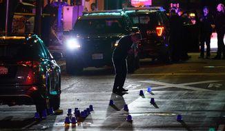 Investigators search for evidence in the area of a mass shooting In Sacramento, Calif. April 3, 2022. (AP Photo/Rich Pedroncelli)