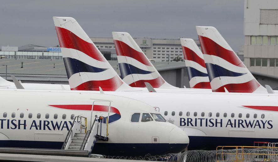 British Airways planes parked at Terminal 5 Heathrow airport in London, Wednesday, March 18, 2020. British travelers going abroad for the Easter holidays faced disruptions Monday, April 4, 2022 as two main carriers, British Airways and easyJet, canceled dozens of flights due to staff shortages related to soaring cases of COVID-19 in the U.K. Budget carrier easyJet grounded 62 flights scheduled for Monday after canceling at least 222 flights over the weekend. (AP Photo/Frank Augstein, File)