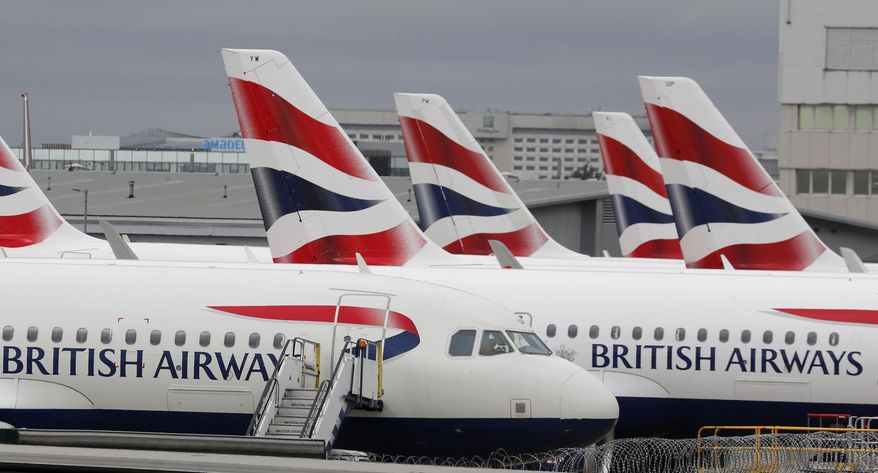 British Airways planes parked at Terminal 5 Heathrow airport in London, Wednesday, March 18, 2020. British travelers going abroad for the Easter holidays faced disruptions Monday, April 4, 2022 as two main carriers, British Airways and easyJet, canceled dozens of flights due to staff shortages related to soaring cases of COVID-19 in the U.K. Budget carrier easyJet grounded 62 flights scheduled for Monday after canceling at least 222 flights over the weekend. (AP Photo/Frank Augstein, File)