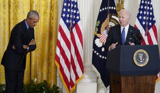 Former President Barack Obama bows in acknowledgment of President Joe Biden as he speaks during an event about the Affordable Care Act, in the East Room of the White House in Washington, Tuesday, April 5, 2022. (AP Photo/Carolyn Kaster)