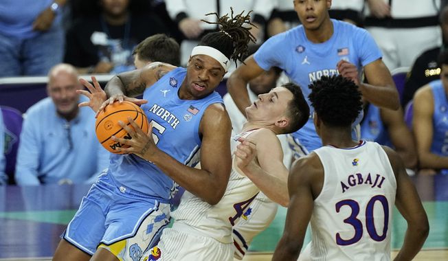 Kansas forward Mitch Lightfoot, right, draws the foul against North Carolina forward Armando Bacot (5) during the second half of a college basketball game in the finals of the Men&#x27;s Final Four NCAA tournament, Monday, April 4, 2022, in New Orleans. (AP Photo/Gerald Herbert) **FILE**