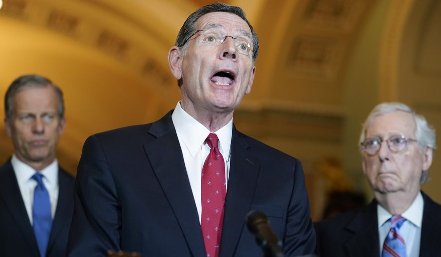 Sen. John Barrasso, R-Wyo., center, speaks to reporters after a Republican strategy meeting at the Capitol in Washington, Tuesday, March 15, 2022. Sen. John Thune, R-S.D., left, and Senate Minority Leader Mitch McConnell, R-Ky., look on. (AP Photo/Mariam Zuhaib)