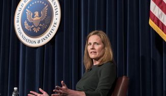 U.S. Supreme Court Associate Justice Amy Coney Barrett speaks with Board of Trustees Chairman Frederick J. Ryan, Jr., at the Ronald Reagan Presidential Library Foundation in Simi Valley, Calif., Monday, April 4, 2022. (AP Photo/Damian Dovarganes)