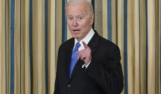 President Joe Biden talks as he leaves after signing the Postal Service Reform Act of 2022 in the State Dining Room at the White House in Washington, Wednesday, April 6, 2022. The long-fought postal overhaul has been years in the making. It comes amid widespread complaints about mail service slowdowns. (AP Photo/Susan Walsh)