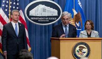 Attorney General Merrick Garland, center, accompanied by Deputy Attorney General Lisa Monaco, right, and FBI Director Christopher Wray, left, speaks at a news conference at the Justice Department in Washington, Wednesday, April 6, 2022, to discuss new and recent enforcement actions to disrupt and prosecute criminal Russian activity. (AP Photo/Andrew Harnik)