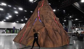 A volcano is built at the center of the Bitcoin 2022 conference in Miami Beach, Fla., Tuesday, April 5, 2022, in Miami Beach, Fla. Miami is gathering thousands of cryptocurrency enthusiasts as it positions itself as one of the hubs of blockchain technology. Dozens of companies are using the Bitcoin 2022 conference as a platform to pitch ideas to investors or share announcements to the crypto world and beyond. (AP Photo/Marta Lavandier)