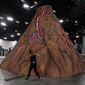 A volcano is built at the center of the Bitcoin 2022 conference in Miami Beach, Fla., Tuesday, April 5, 2022, in Miami Beach, Fla. Miami is gathering thousands of cryptocurrency enthusiasts as it positions itself as one of the hubs of blockchain technology. Dozens of companies are using the Bitcoin 2022 conference as a platform to pitch ideas to investors or share announcements to the crypto world and beyond. (AP Photo/Marta Lavandier)