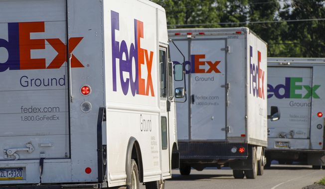 FILE - Delivery vehicles depart the FedEx Ship Center in Cranberry Township, Pa., on June 26, 2019. Shipping giant FedEx Corp. says its logistics subsidiary has opened a new global headquarters in downtown Memphis, Tenn. FedEx Logistics says it held an event Tuesday, April 5, 2022, to mark the opening of its offices in the former Gibson guitar factory, just steps from historic Beale Street and the FedExForum sports and concert venue in Memphis. (AP Photo/Keith Srakocic, File)