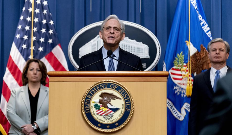 Attorney General Merrick Garland, center, accompanied by Deputy Attorney General Lisa Monaco, left, and FBI Director Christopher Wray, right, speaks at a news conference at the Justice Department in Washington, Wednesday, April 6, 2022, to discuss new and recent enforcement actions to disrupt and prosecute criminal Russian activity. (AP Photo/Andrew Harnik)