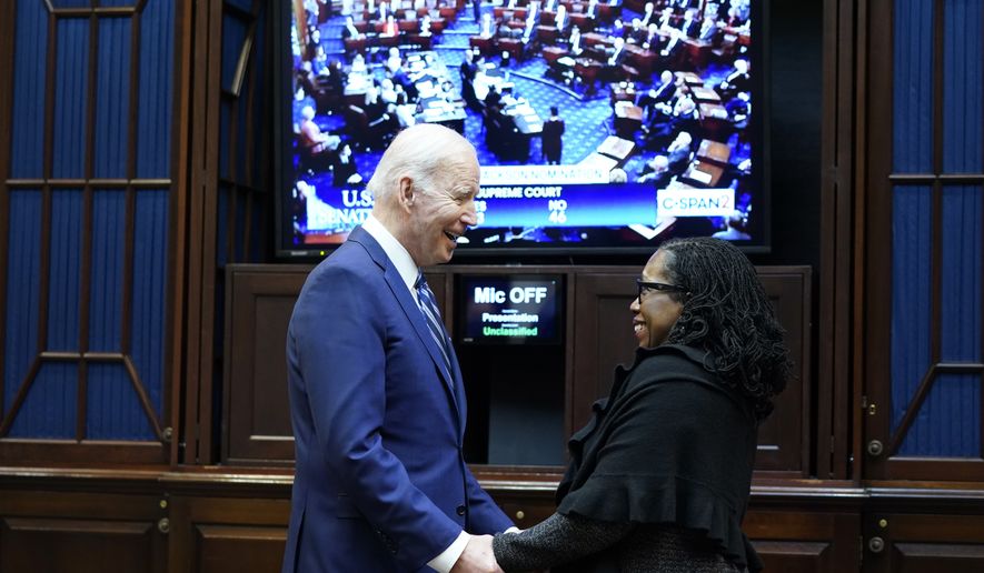 President Joe Biden talks with Supreme Court nominee Judge Ketanji Brown Jackson as they watch the Senate vote on her confirmation from the Roosevelt Room of the White House in Washington, Thursday, April 7, 2022. (AP Photo/Susan Walsh)
