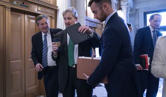 Sen. Steve Daines, R-Mont., left, and Sen. John Kennedy, R-La., arrive at the chamber for a vote to suspend normal trade relations treatment for the Russian Federation and the Republic of Belarus, at the Capitol in Washington, Thursday, April 7, 2022. (AP Photo/J. Scott Applewhite)