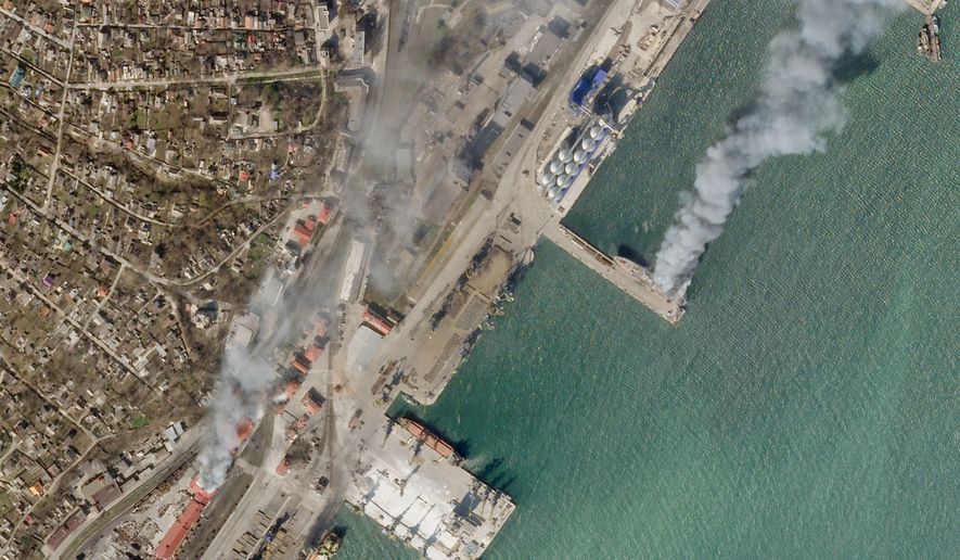 In this satellite photo from Planet Labs PBC, a Ukrainian naval vessel and a nearby building burn in the besieged city of Mariupol, Ukraine, Wednesday, April 6, 2022. The photo appears to show the Ukrainian command ship Donbas burning at the port in Mariupol, as a nearby building also burned around 2:30 p.m. local time Wednesday. A cause for the fire remained unclear. (Planet Labs PBC via AP)