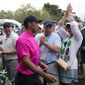 Spectators cheer as Tiger Woods heads to the first tee during the first round at the Masters golf tournament on Thursday, April 7, 2022, in Augusta, Ga. (AP Photo/Charlie Riedel)