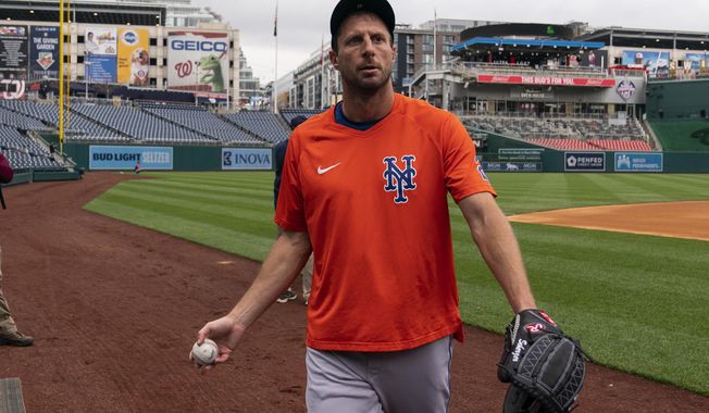 New York Mets starting pitcher Max Scherzer walks off the field after a baseball workout at Nationals Park, Wednesday, April 6, 2022, in Washington. The Washington Nationals and the New York Mets are scheduled to play on opening day, Thursday. (AP Photo/Alex Brandon)
