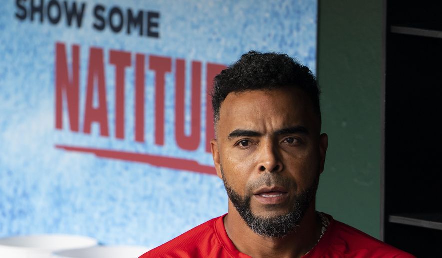 Washington Nationals designated hitter Nelson Cruz pauses in the dugout during a baseball workout at Nationals Park, Wednesday, April 6, 2022, in Washington. The Washington Nationals and the New York Mets are scheduled to play on opening day, Thursday. (AP Photo/Alex Brandon) **FILE***